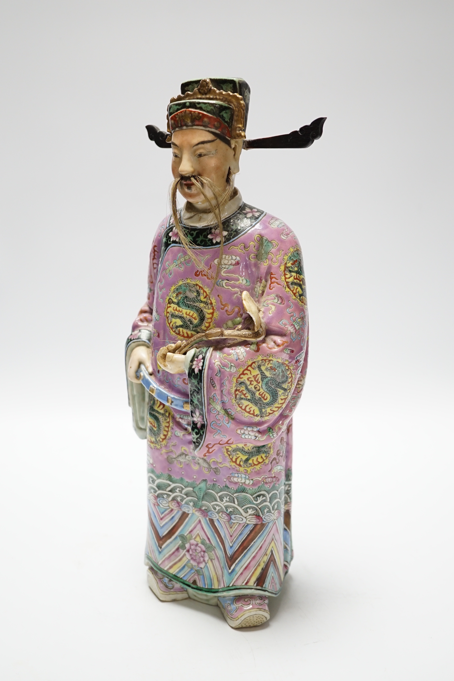 An early 20th century Chinese enamelled porcelain figure of an immortal, 31.5 cm high